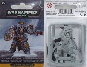 Colorful Warhammer 40,000 miniatures: painted Space Marine and unpainted Citadel Finecast collectible.