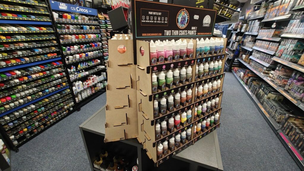 Colorful paint bottle display in an inviting art supply store, perfect for artists and creators.